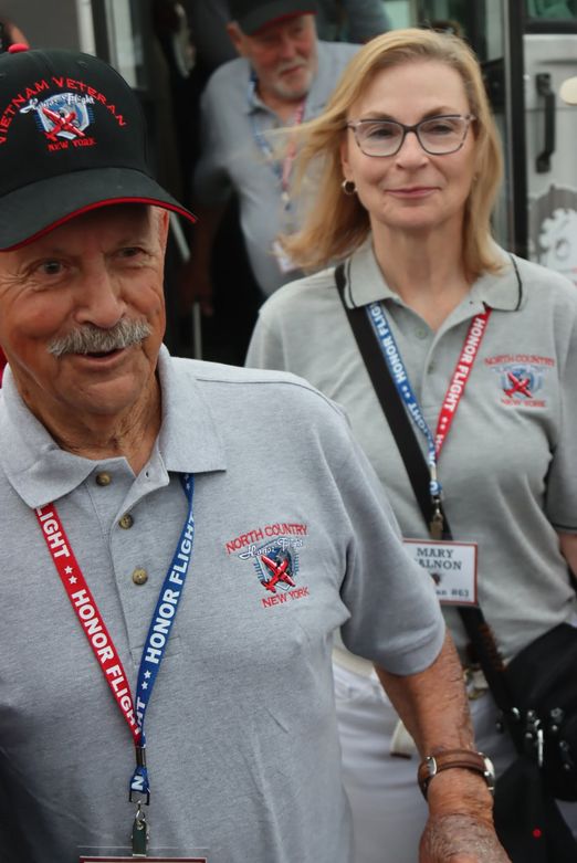 a Vietnam veteran and his guardian boarding the bus for an Honor Flight