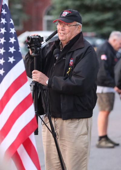 volunteer beside the American flag at a send-off ceremony