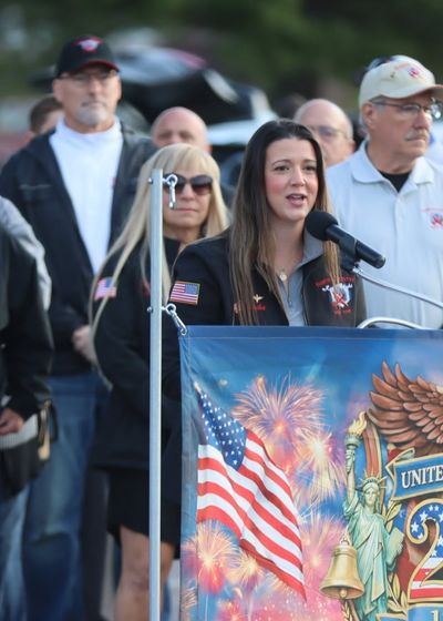 speaker addressing the crowd at an Honor Flight ceremony