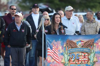 speaker addressing the crowd at an Honor Flight ceremony